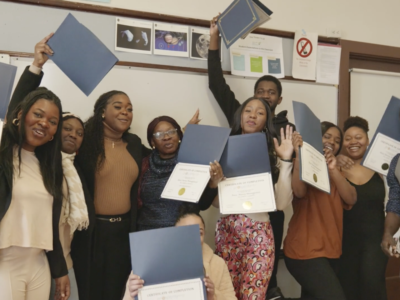 students displaying certificates