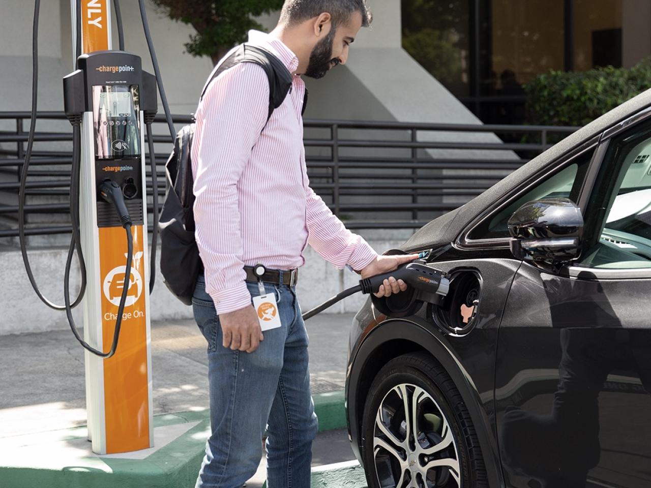 person charging a car