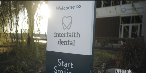Sign showing: Welcome to interfaith dental; start smiling. 