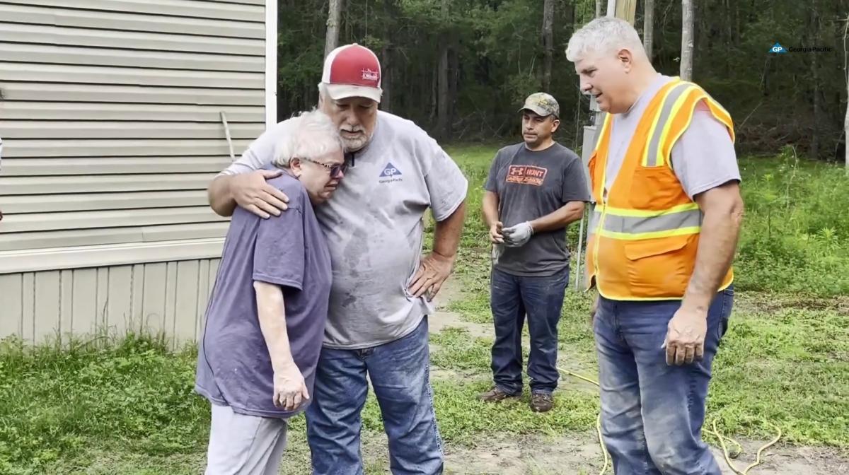 Volunteers hugging Lillian