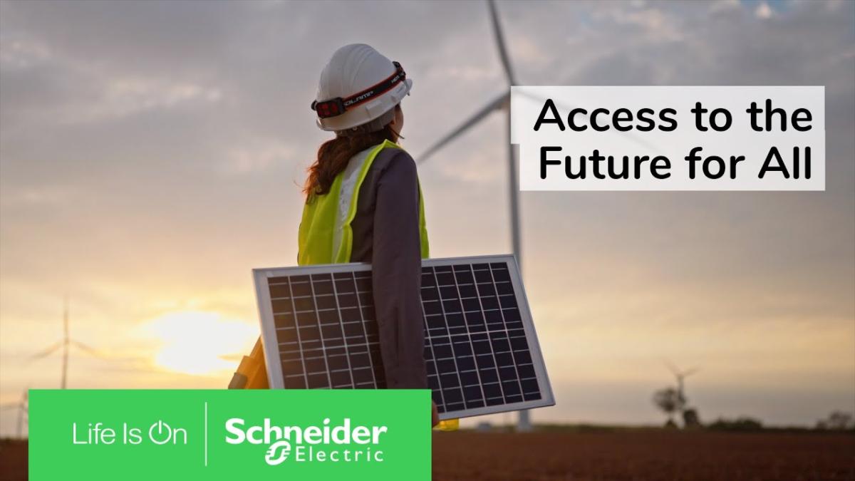 A person carrying a solar panel outside. A wind turbine in the distance. Schneider Electric logo. 