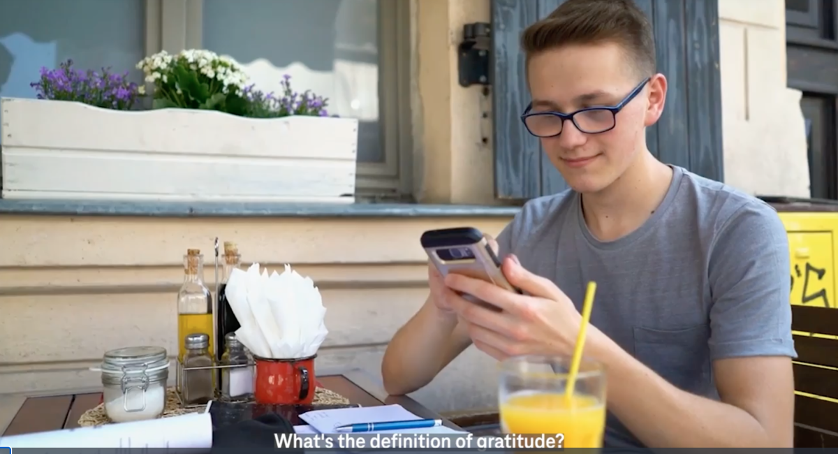 Person on phone at breakfast