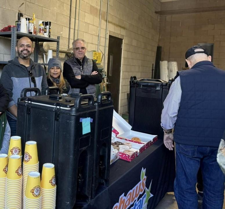 People serving coffee and donuts at Wreaths Across America event