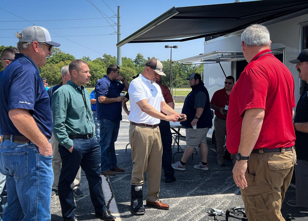 People gathered together around a drone