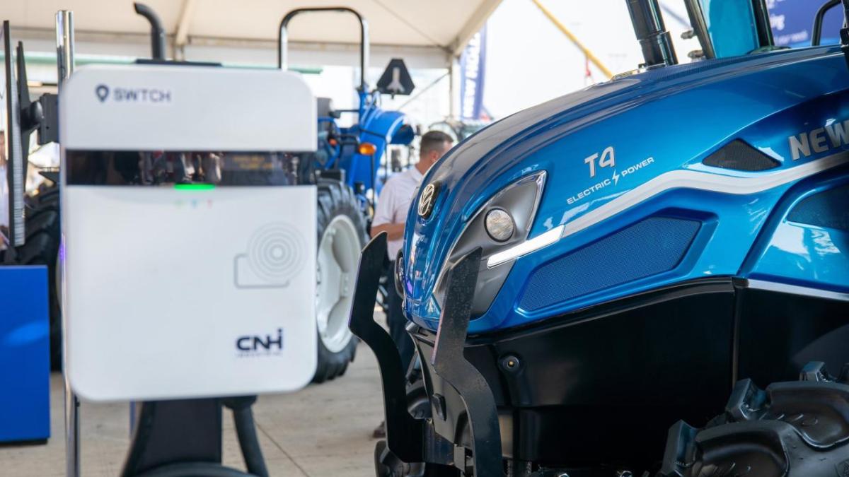 Blue tractor near an electric charger