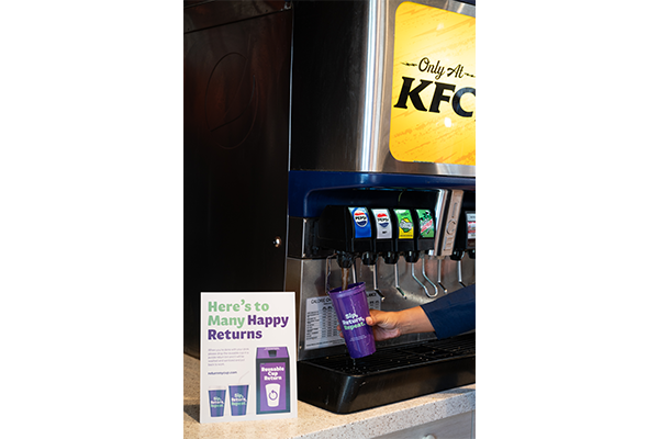 A reusable purple cup being filled