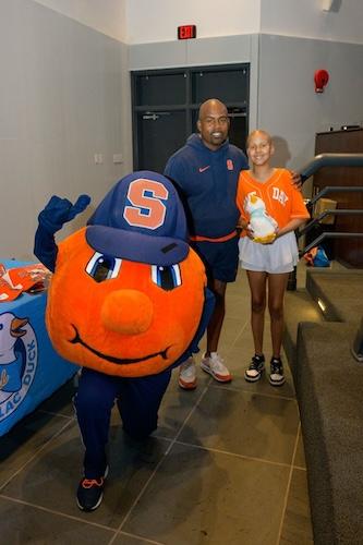 Judy with Syracuse Head Football Coach Fran Brown and the Syracuse mascot.