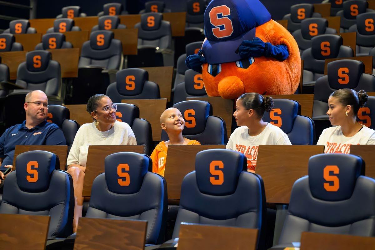 Judy in the stands with the Syracuse mascot.