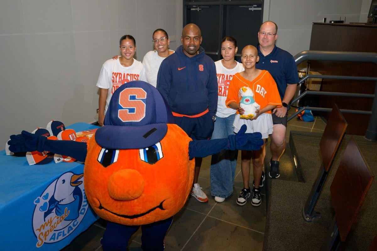 Judy with her family and Syracuse Head Football Coach Fran Brown.