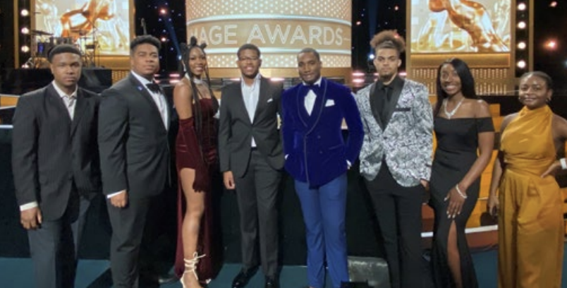 A group of people in formal clothing at a award show