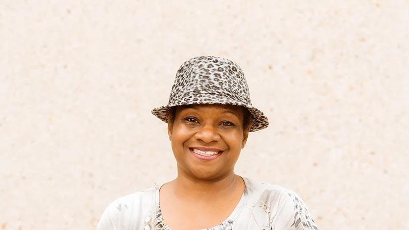 Headshot of a person wearing a hat