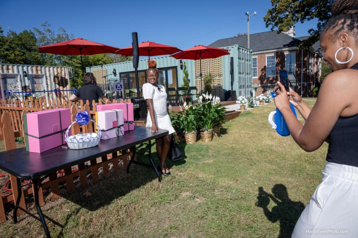 Photo of a woman posing while another woman takes her photo