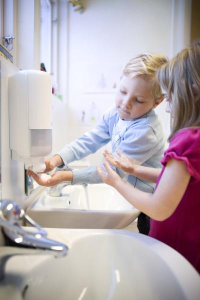 Children washing their hands.