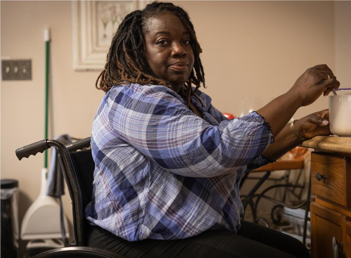 Photo of Melanie shown seated in a wheelchair.