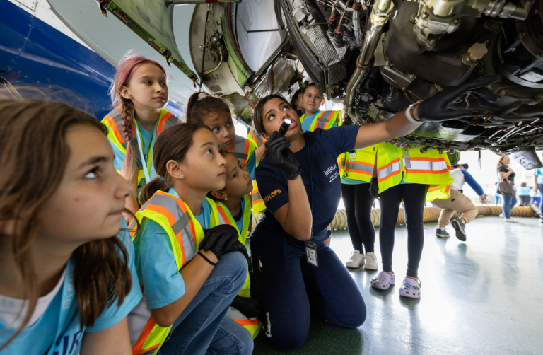 girls looking at an airplane