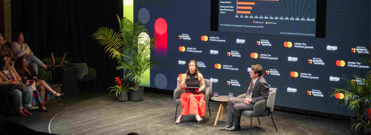 two people on stage during the Global Inclusive Growth Summit