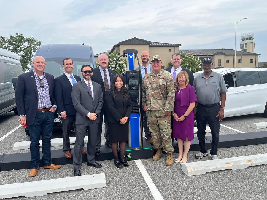 Leaders from Leidos, the Defense Innovation Unit, and the Office of the Deputy Assistant Secretary of the Air Force for Environment, Safety, and Infrastructure celebrate the official EV Charging as a Service ribbon cutting at Dover AFB. Photo: Airman Liberty Matthews