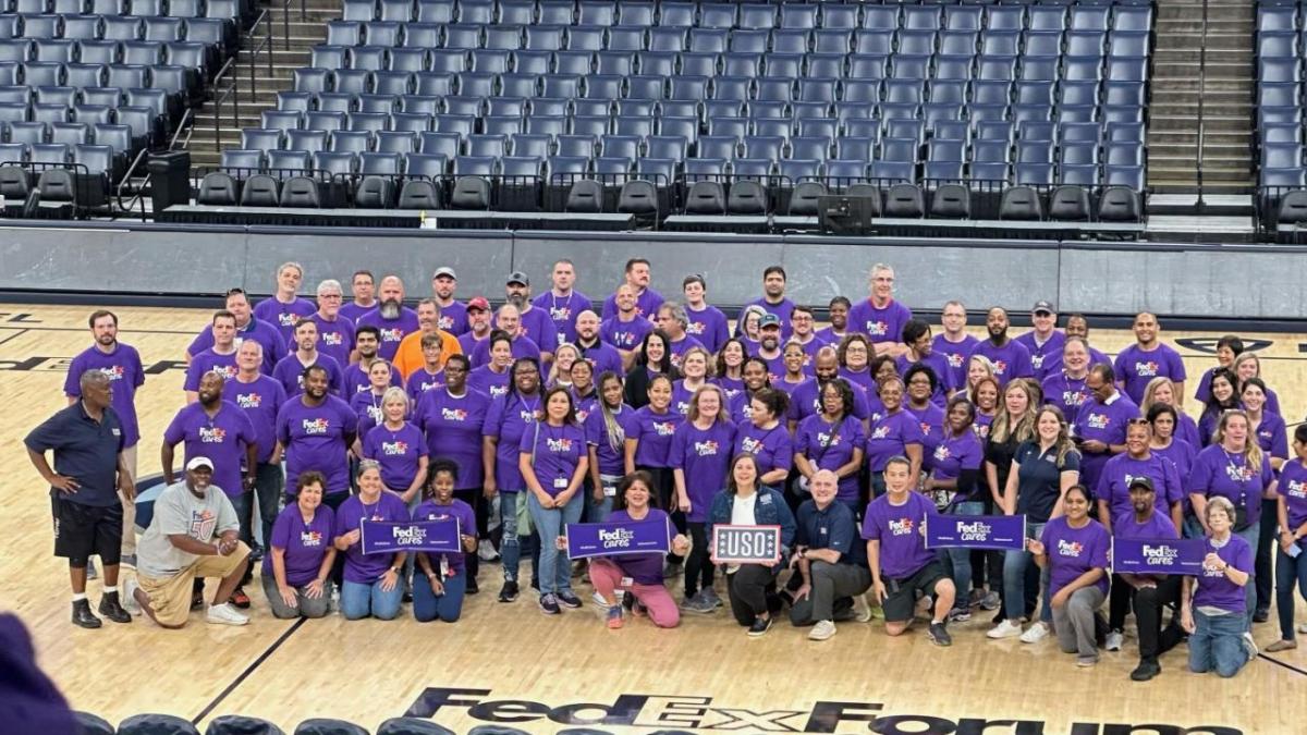 Large group photo of people wearing purple Fedex cares tshirts