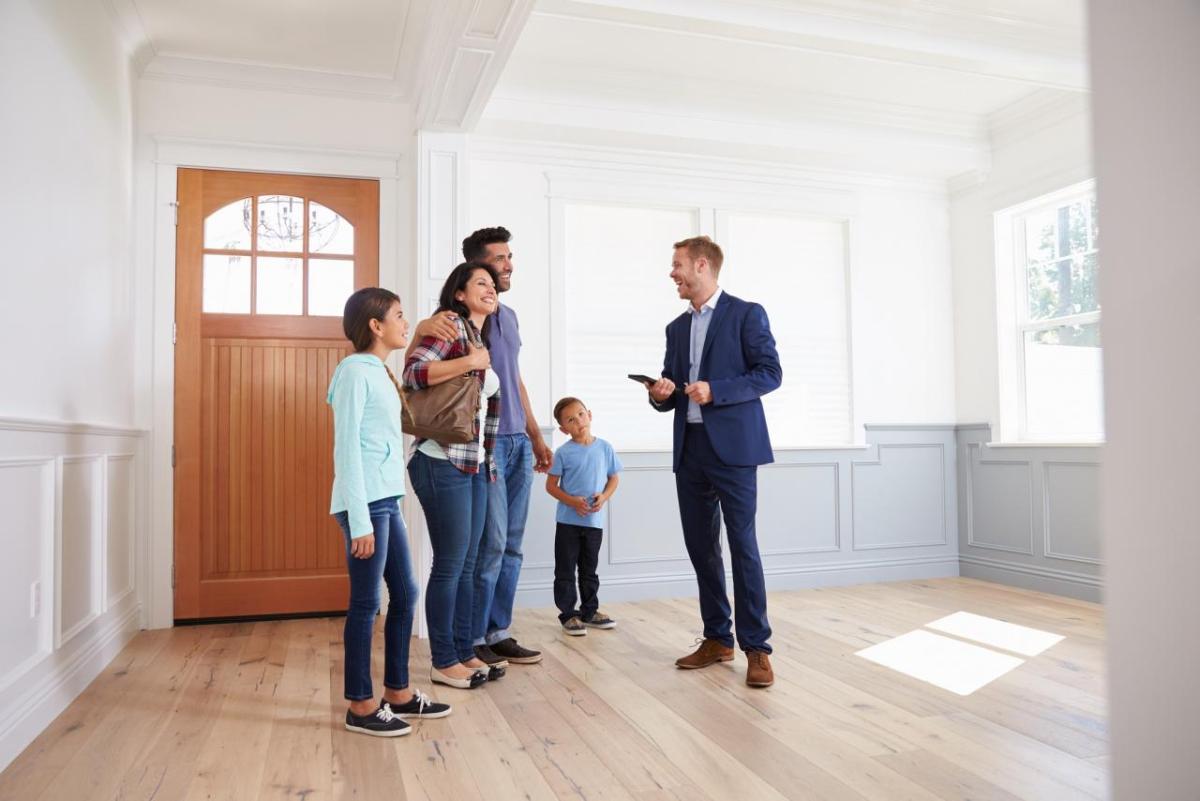 Photo of family touring a house for possible purchase.