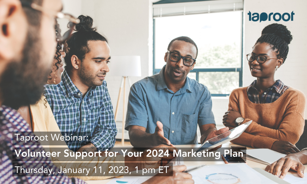 A professional team sits around an indoor table, listening to their colleague speak. Text overlay shares information on Taproot's free webinar on marketing pro bono.