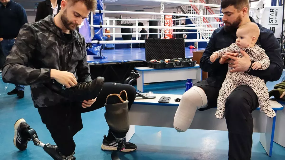 Co-founder of Danish NGO Levitate, Lasse Madsen, fits a shoe to a new "everyday foot" built for Ukrainian soldier Volodymyr, who lost his right foot in combat in Summer 2023. Volodymyr was the first recipient of a sports prosthetic from Levitate when it expanded its operations to Ukraine later that year. Direct Relief has supported rehabilitation services since the beginning of the war. (Nick Allen/Direct Relief)