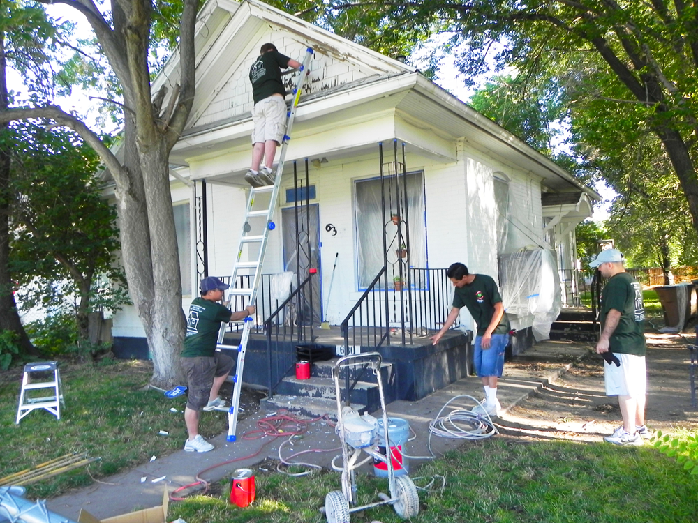 Group of people painting house