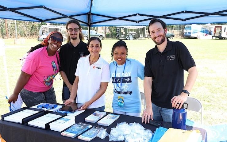 volunteers at a booth