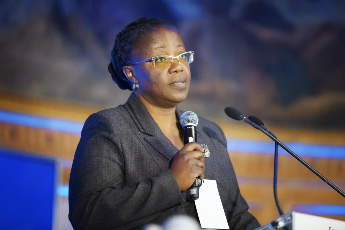 Dr. Jeanne d’Arc Mujawamariya speaks at a lectern on stage.