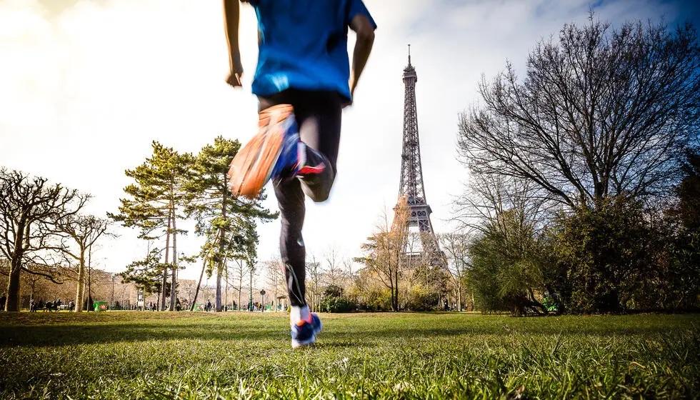 A person running towards the Eiffel tower 