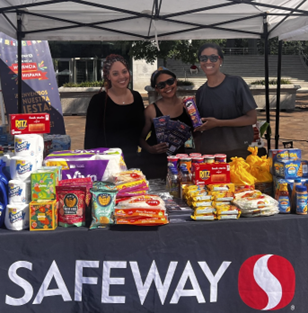 People posing at booth with "Safeway" logo