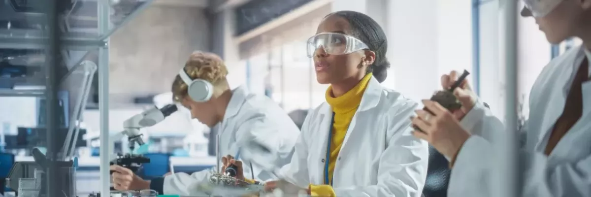 Students in protective lab gear working on projects