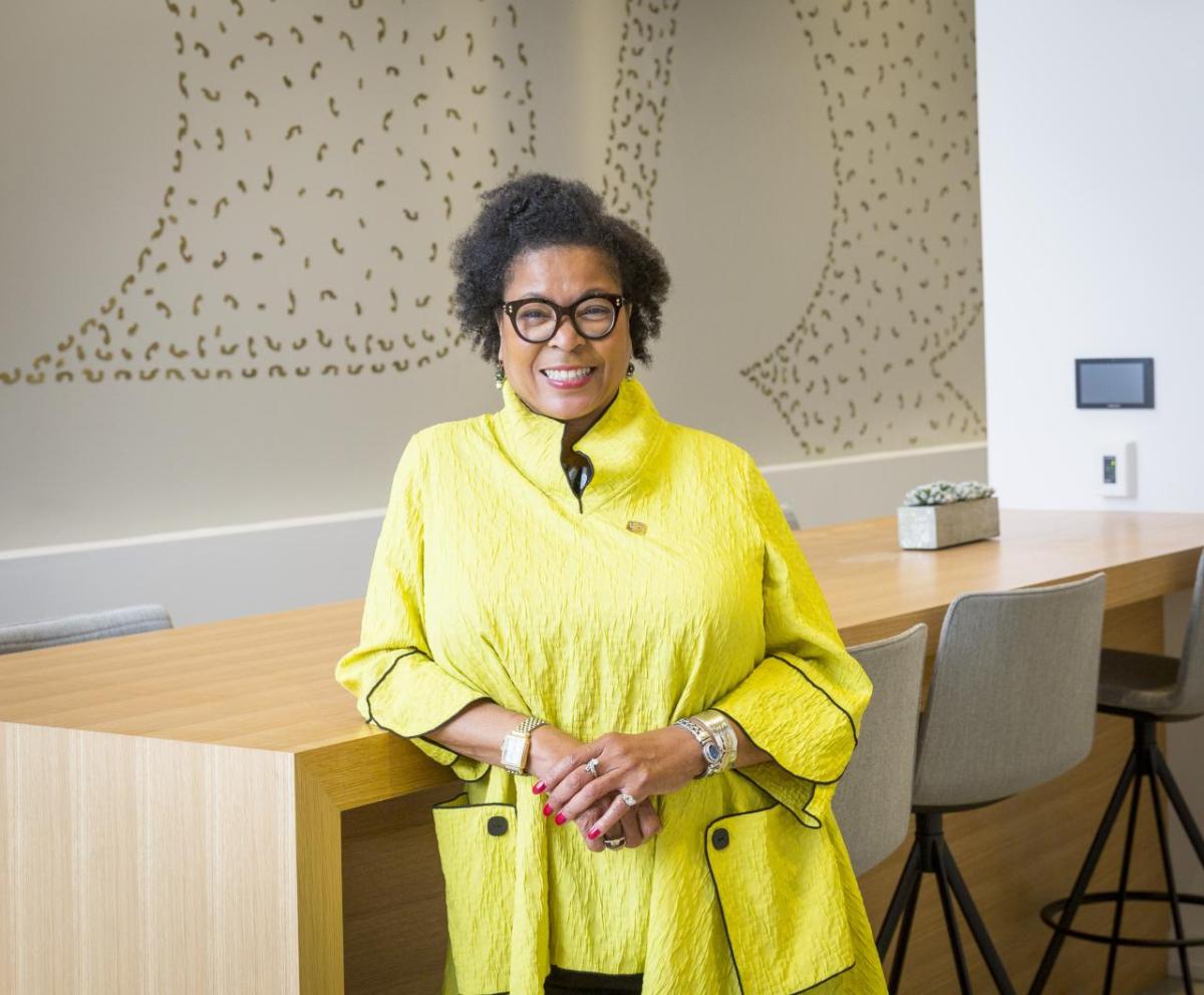 Stephanie A. Smith leaning against a table