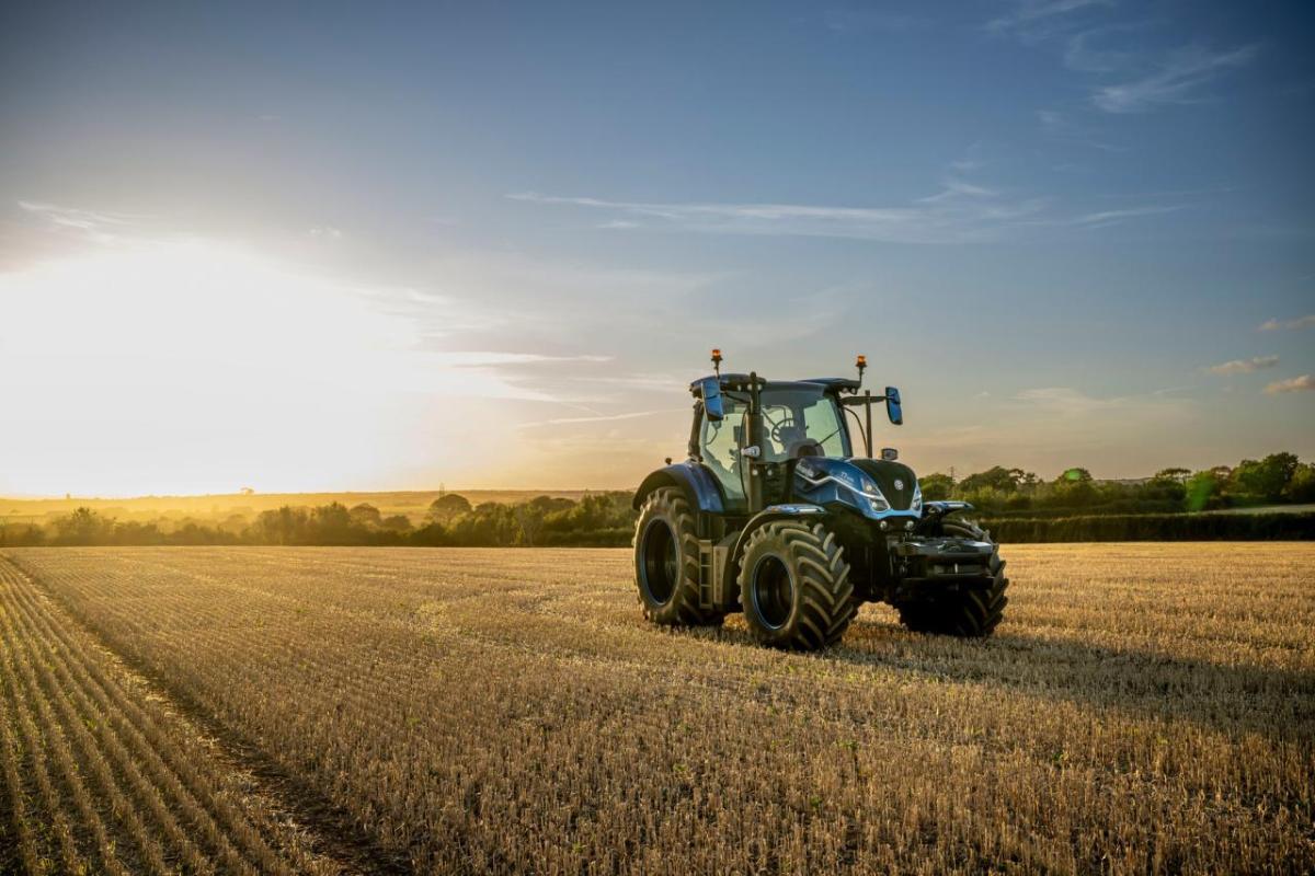 tractor on a field at dawn