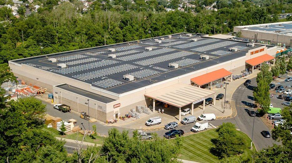 Solar panel array shown on rooftop of Home Depot building.
