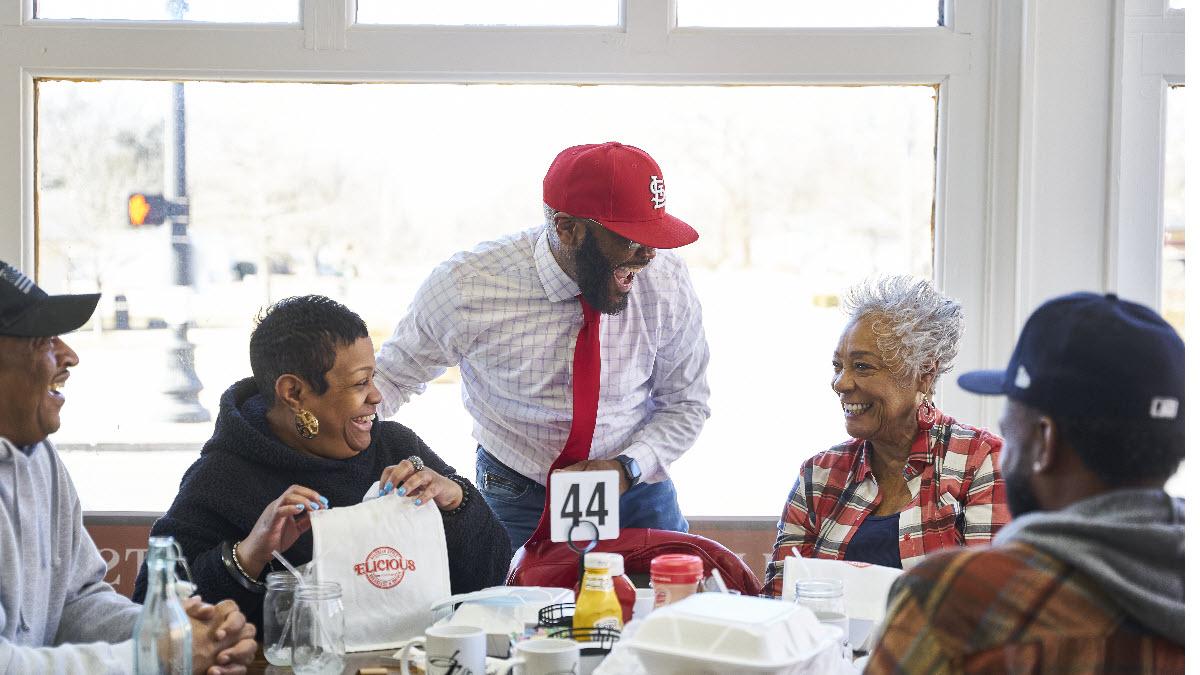 Johnny Little chatting with customers at his Southern-style breakfast and brunch restaurant Elicious in Ferguson, Missouri.