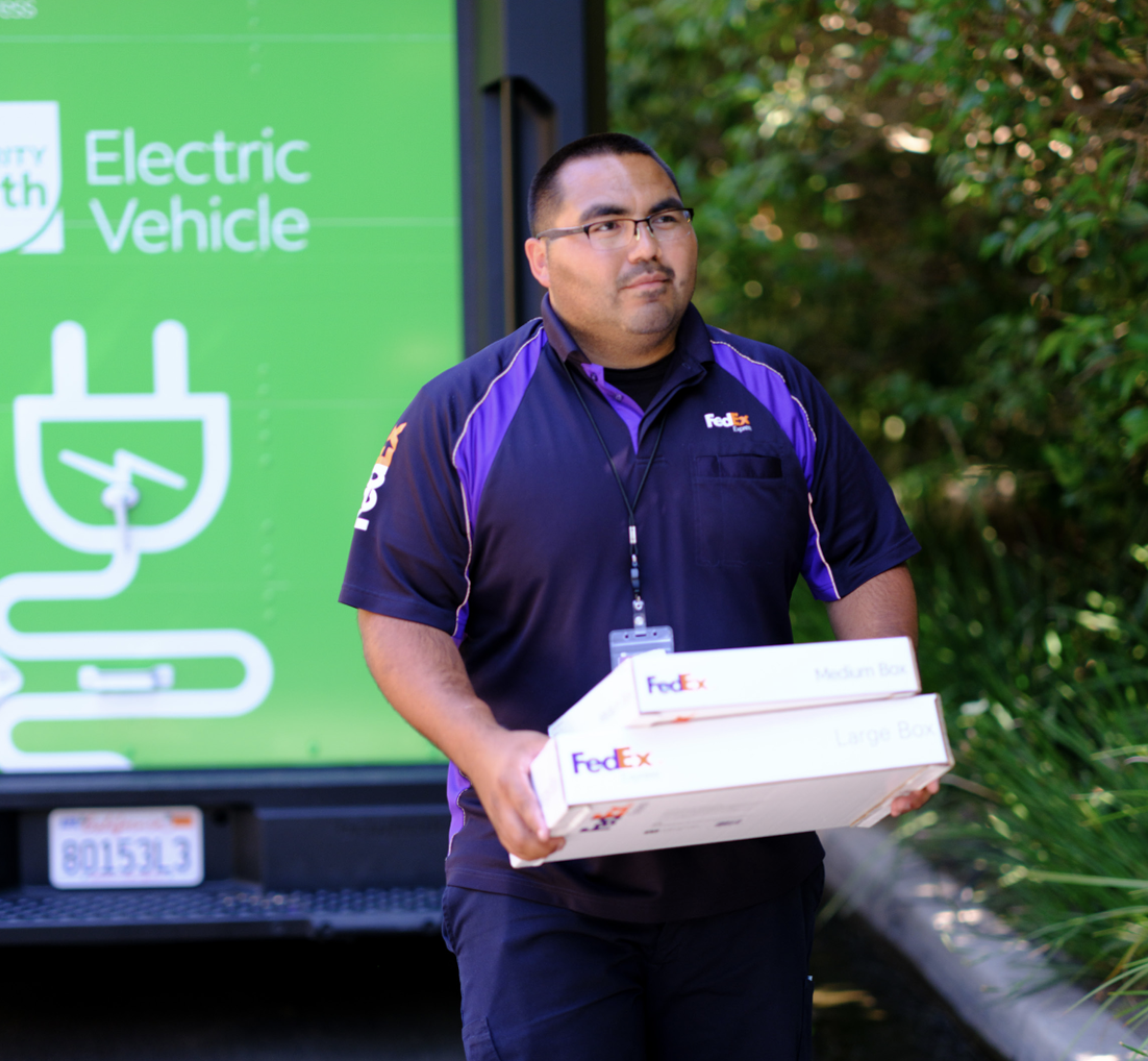 FedEx employee carrying 2 delivery boxes