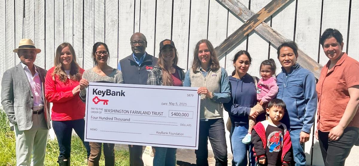 Representatives from KeyBank and Washington Farmland Trust shown with a $400,000 grant check.