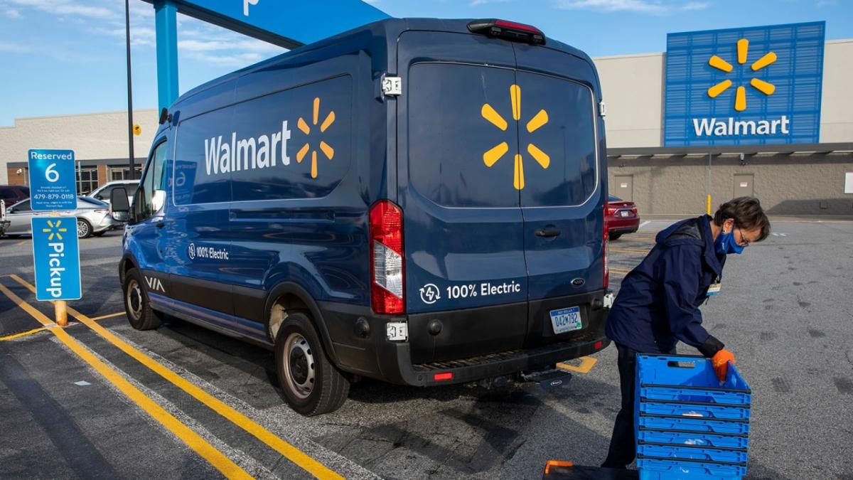 person packing an electric Walmart van