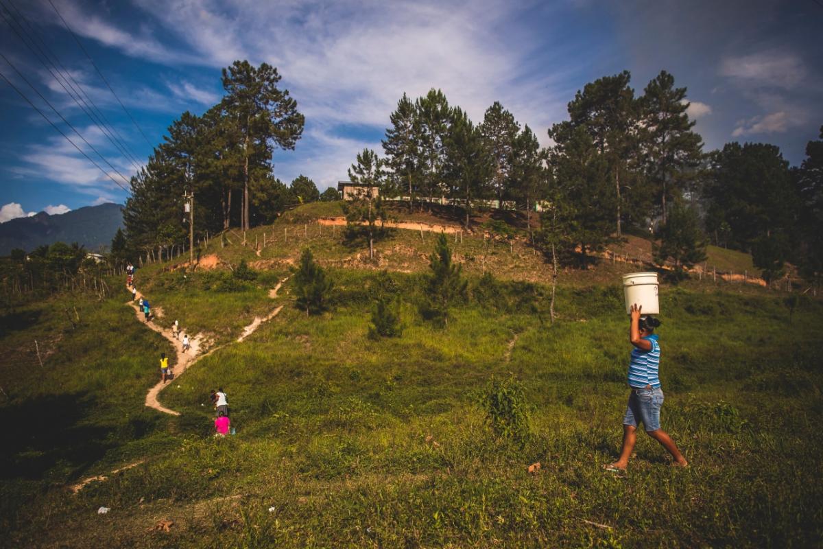 People carrying water bucket