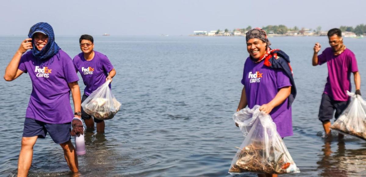 Group of Volunteers holding bags in water