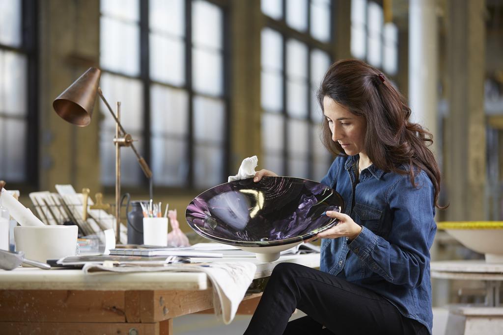 Sitting woman looking at a bowl