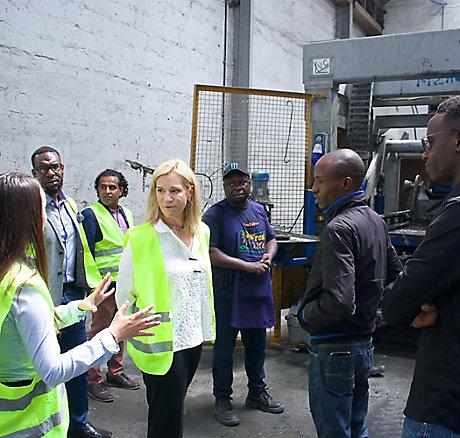 Laura Kohler meeting with group in yellow high visibility jackets