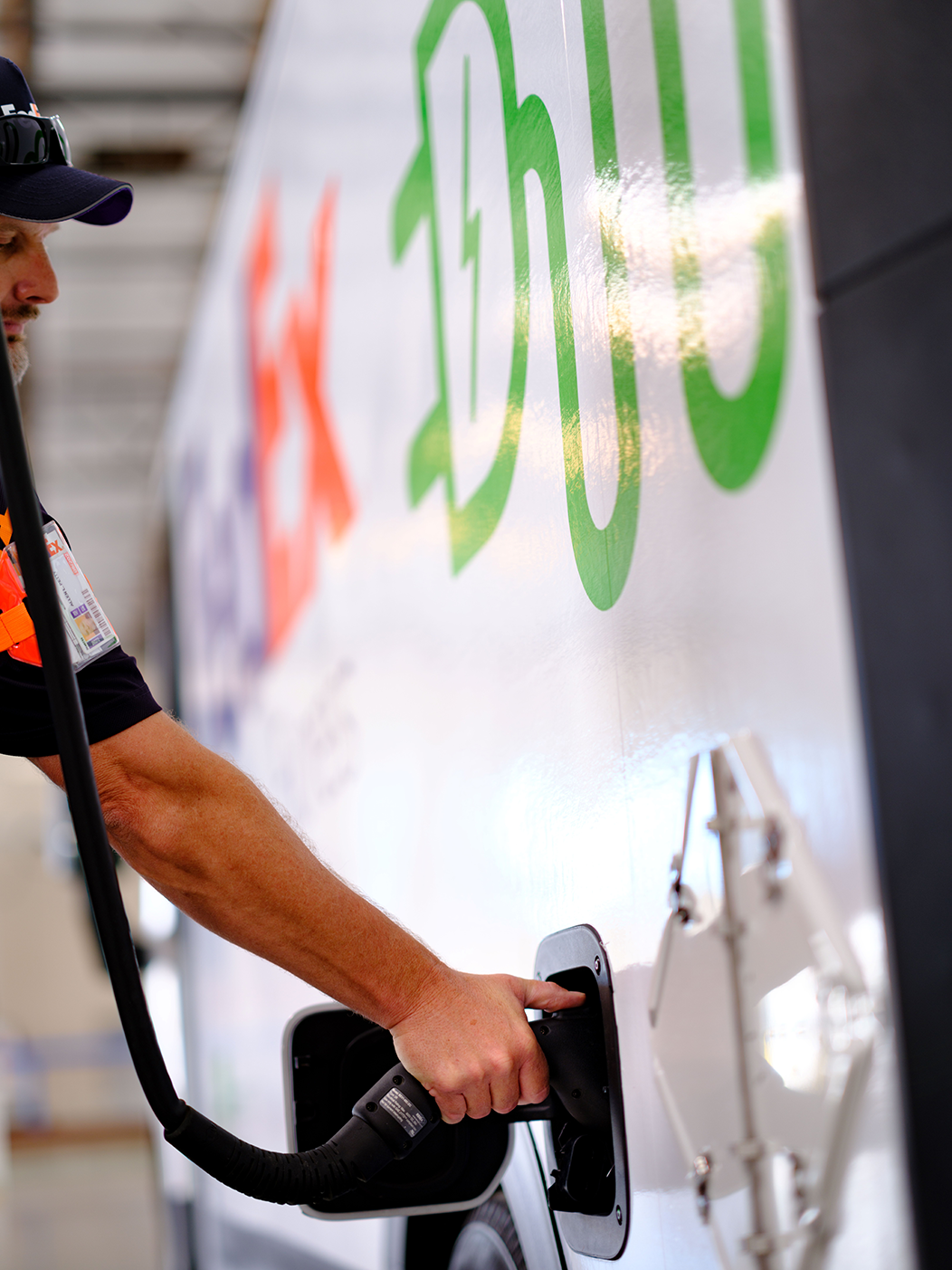 Someone fueling a FedEx vehicle