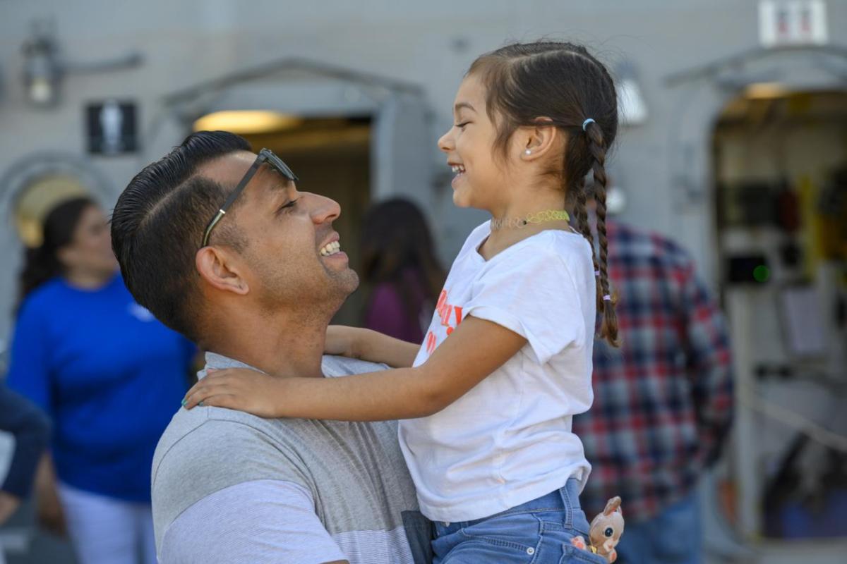 Parent holding child and smiling