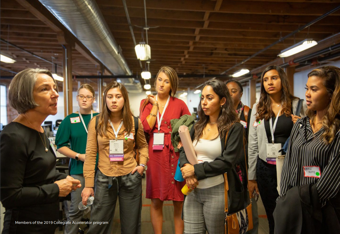 A woman talking to a group of women that are part of the 2019 Collegiate Accelerator program
