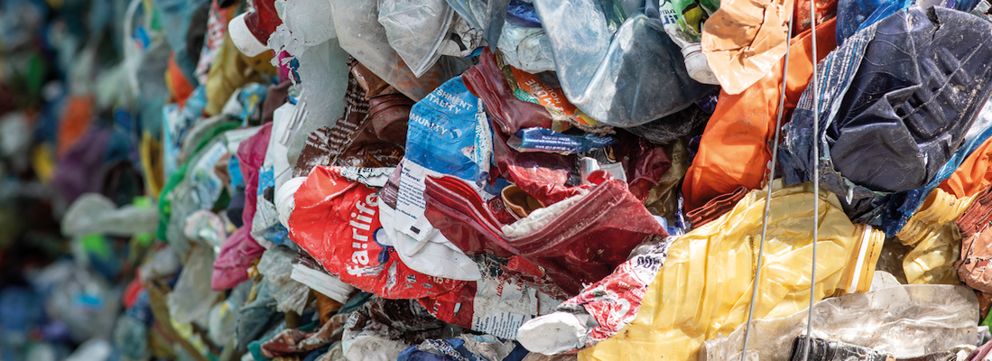 Plastic waste shown in the process of being sorted for recycling.