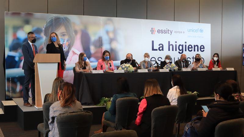 Speakers on stage in front of an Essity banner