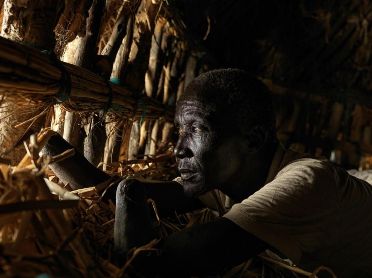 Deng Yell lost both his hands in the war and remains isolated on his floating home. The home is floating due to tightly packing layers of grass on the floor, which acts as a floating pontoon.