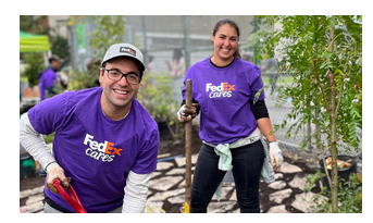 Two volunteers with shovels.