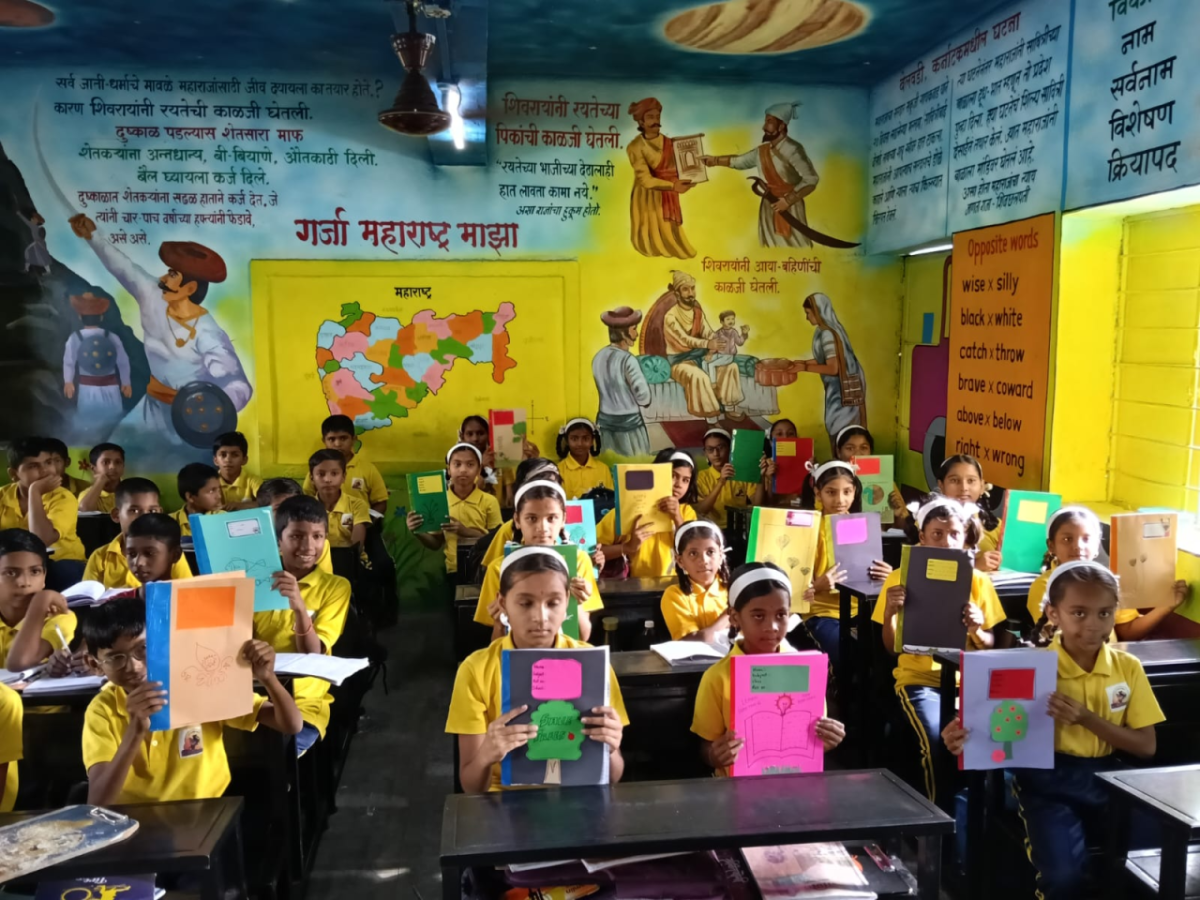 Children receiving recycled notebooks